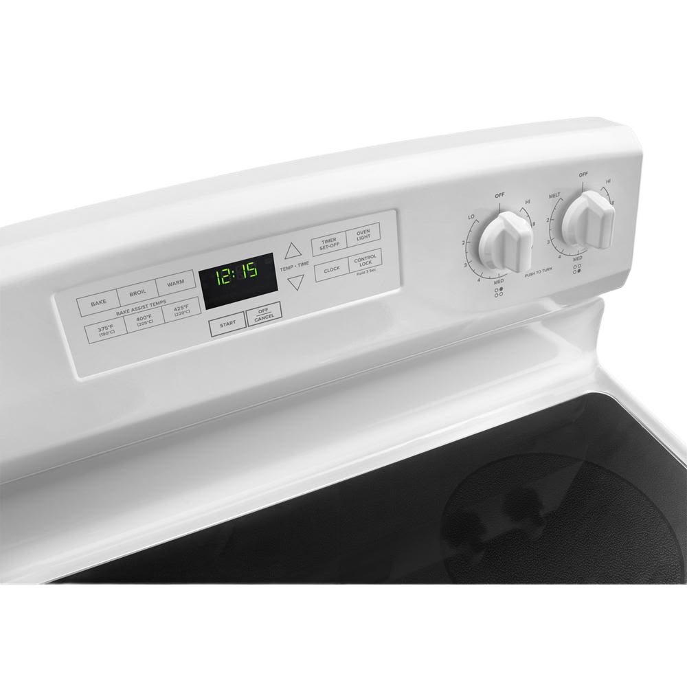 Close-up of white electric range control panel with digital clock, Bake Assist buttons, and two burner control knobs for kitchen appliances collection
