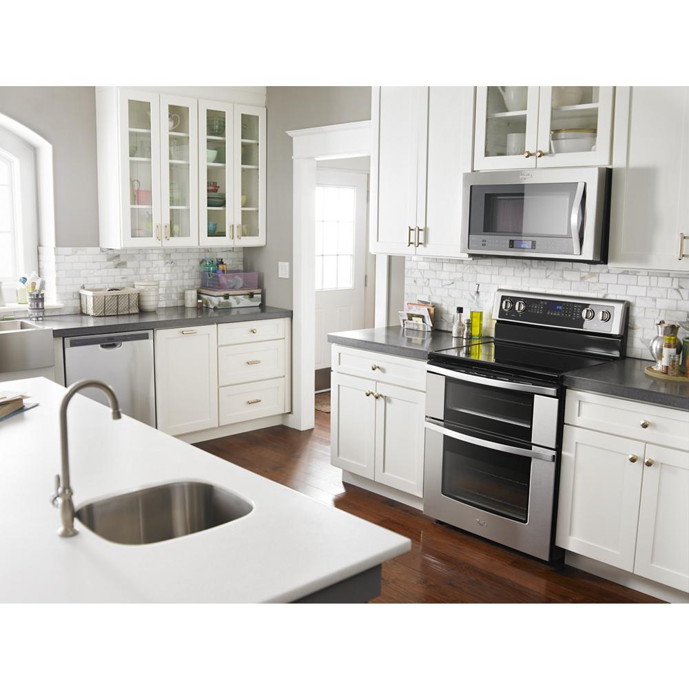 Modern kitchen featuring stainless steel electric double oven range with true convection and white cabinetry