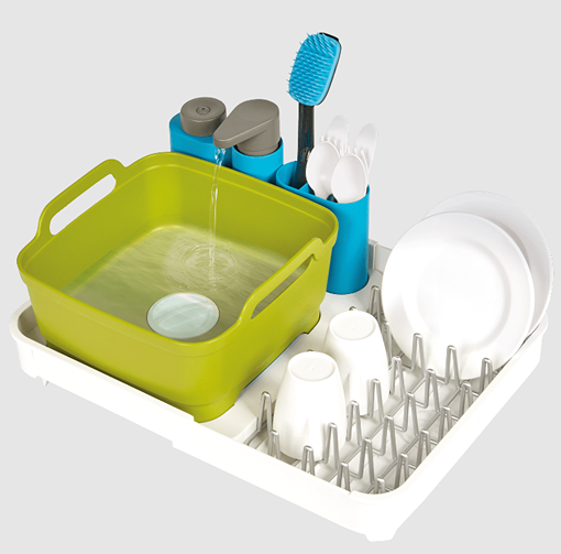 Plastic dish washing set with green basin, blue compartments, and white drying rack holding plates and cups