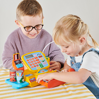 Two children playing with a colorful interactive Casdon Cash Register from the Pretend Play Toys collection under $50