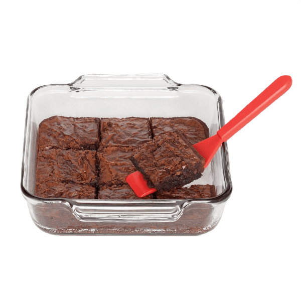 Red baking spatula lifting a brownie square from a glass baking dish in kitchen utensils and cookware collections