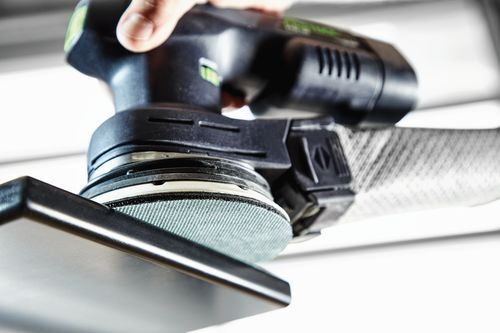 Cordless eccentric sander with dust extraction attachment sanding a metal surface for home improvement tasks