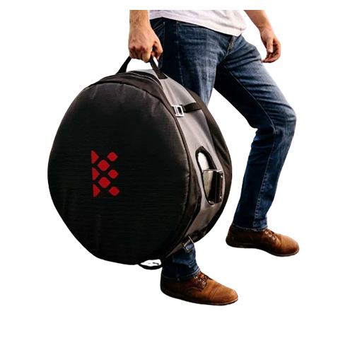 Person carrying black and gray padded transit case with red logo for fire pits in outdoor living and patio furniture settings