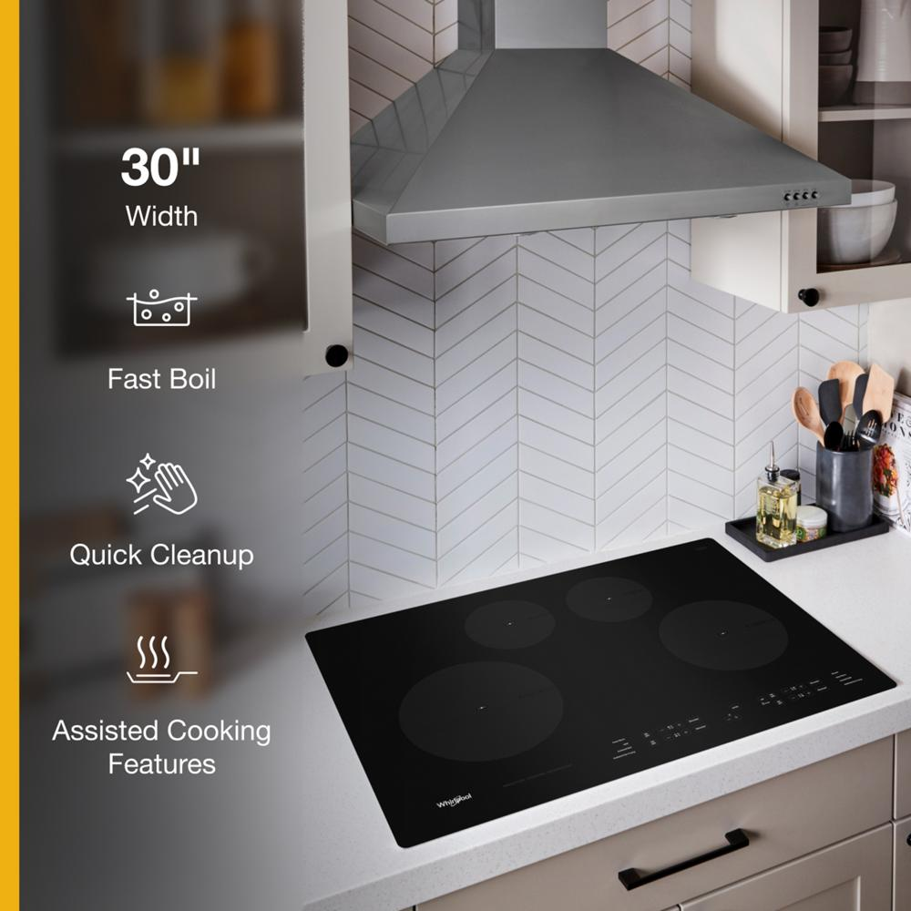 Black 30-inch induction cooktop with four cooking zones and touch controls in modern kitchen setup