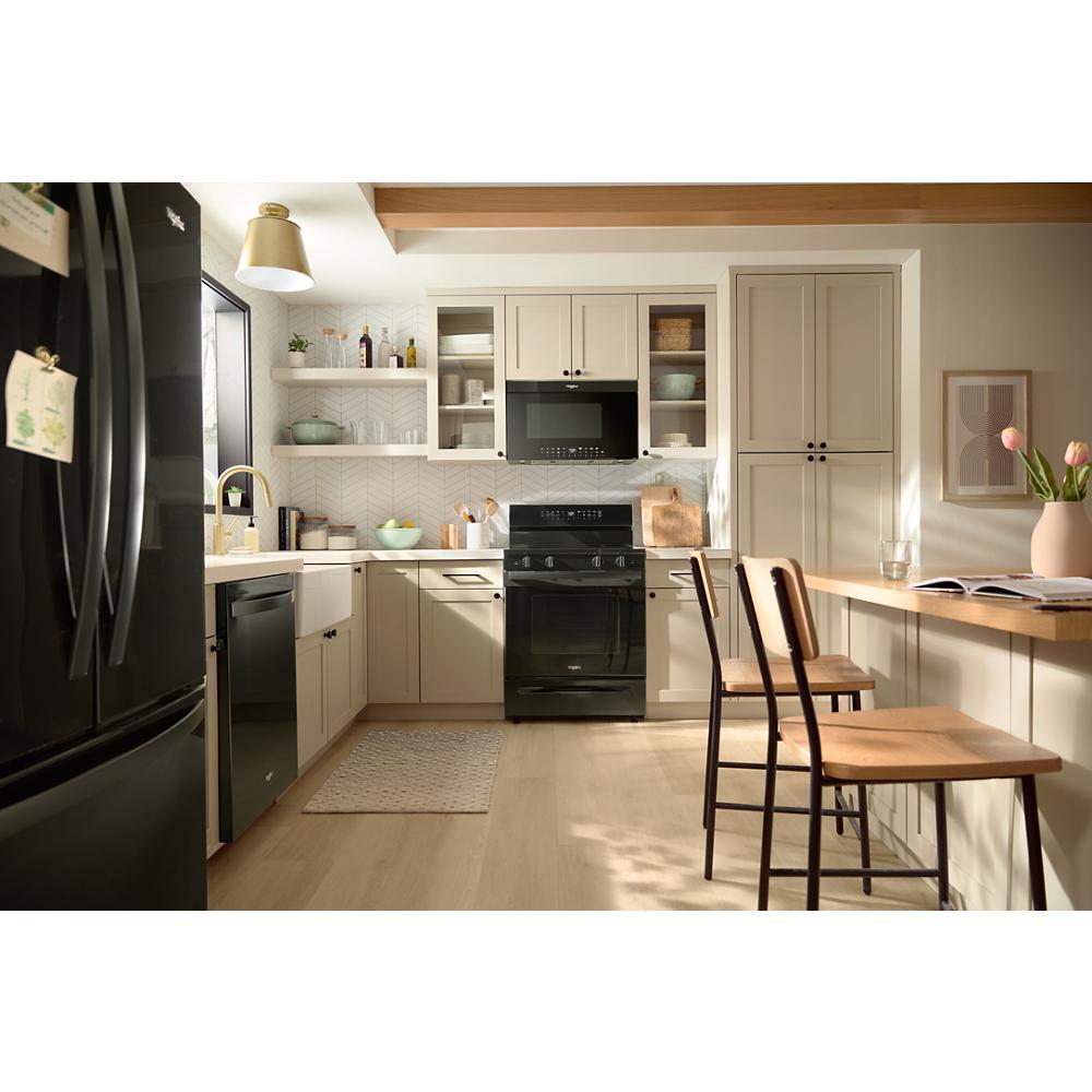 Bright modern kitchen with beige cabinets, black appliances including air fry over-the-range oven and refrigerator door in view