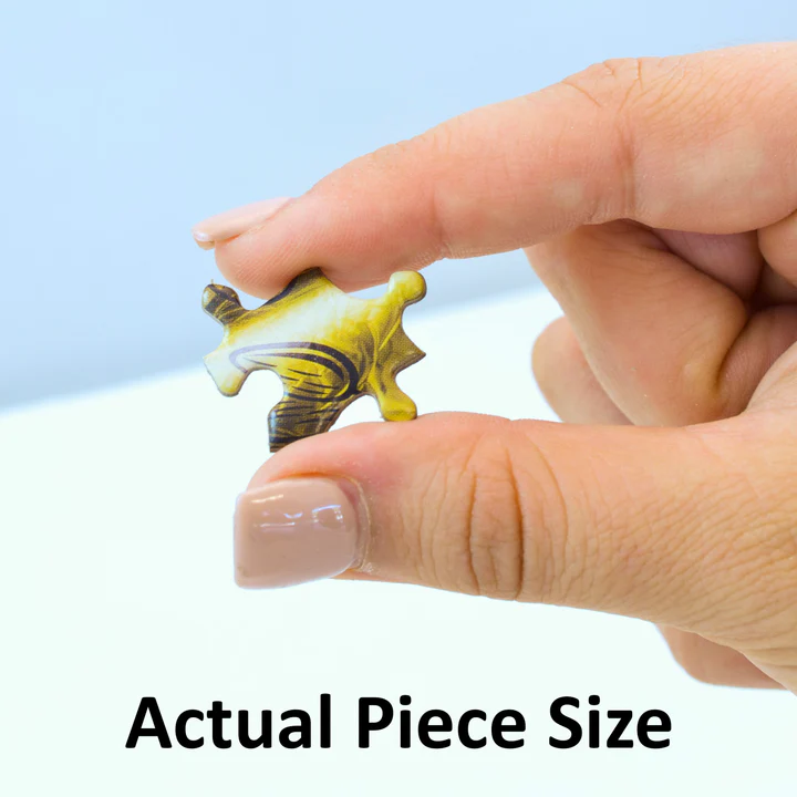 Hand holding a single yellow and brown puzzle piece from a 300-piece Sasquatch puzzle in toys and games collection