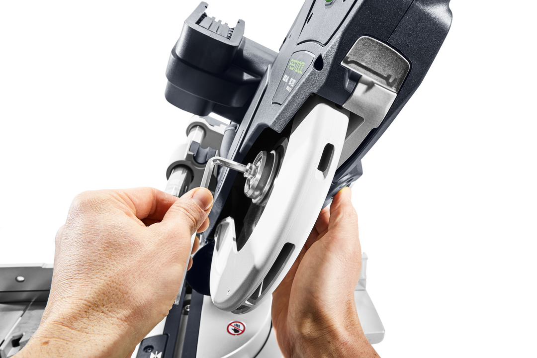 Person adjusting blade on a cordless compound miter saw from a woodworking power tools collection