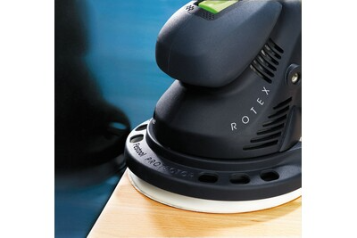 Close-up of Festool ROTEX sander on wooden surface showing ergonomic handle and ventilation slots for tools and home improvement use