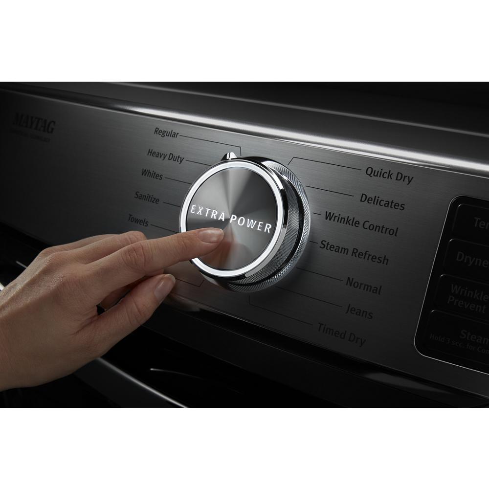 Finger pressing metallic Extra Power dial on a gas dryer control panel in Dryers and Appliances collections
