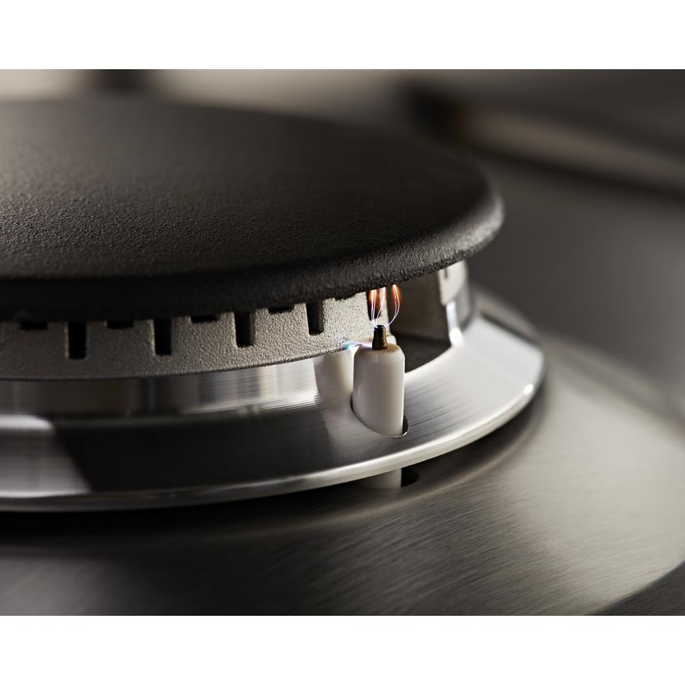Ignition flame lighting the burner on a stainless steel 36-inch gas cooktop in Cooktops and Kitchen & Kitchenware collections