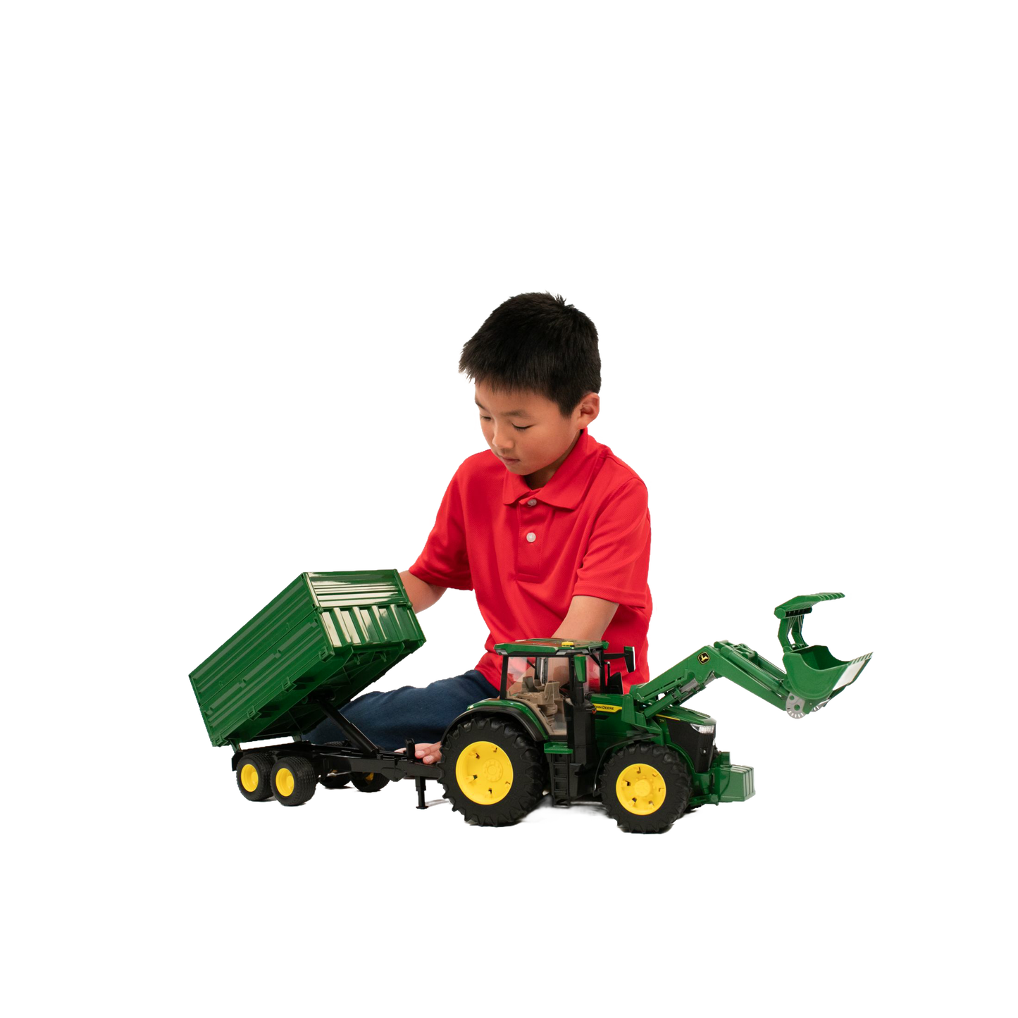 Child in red shirt playing with green Bruder John Deere toy tractor and tipping trailer in Vehicles & Remote Controlled Toys collection