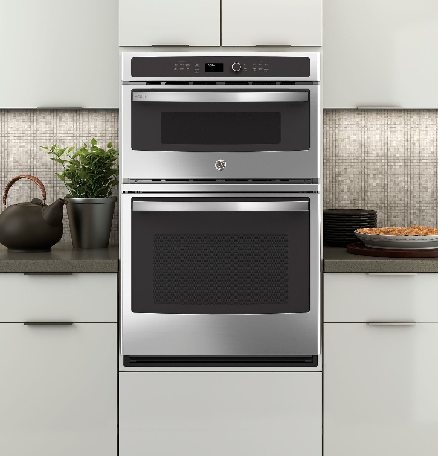 Front view of a stainless steel built-in combination convection microwave and wall oven in modern kitchen setting