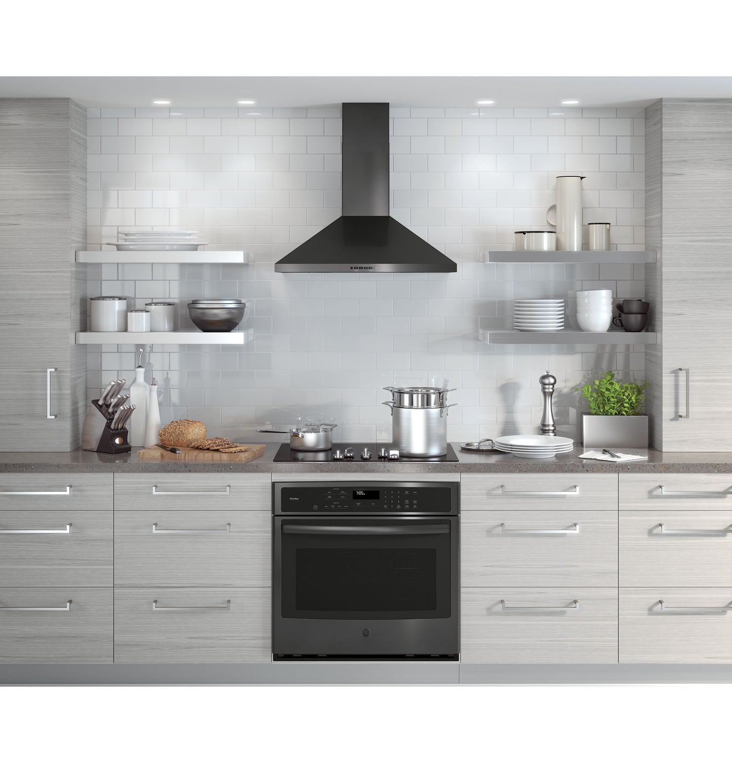 Modern kitchen featuring a black pyramid wall-mount chimney hood over a stainless steel stove in Appliances collection