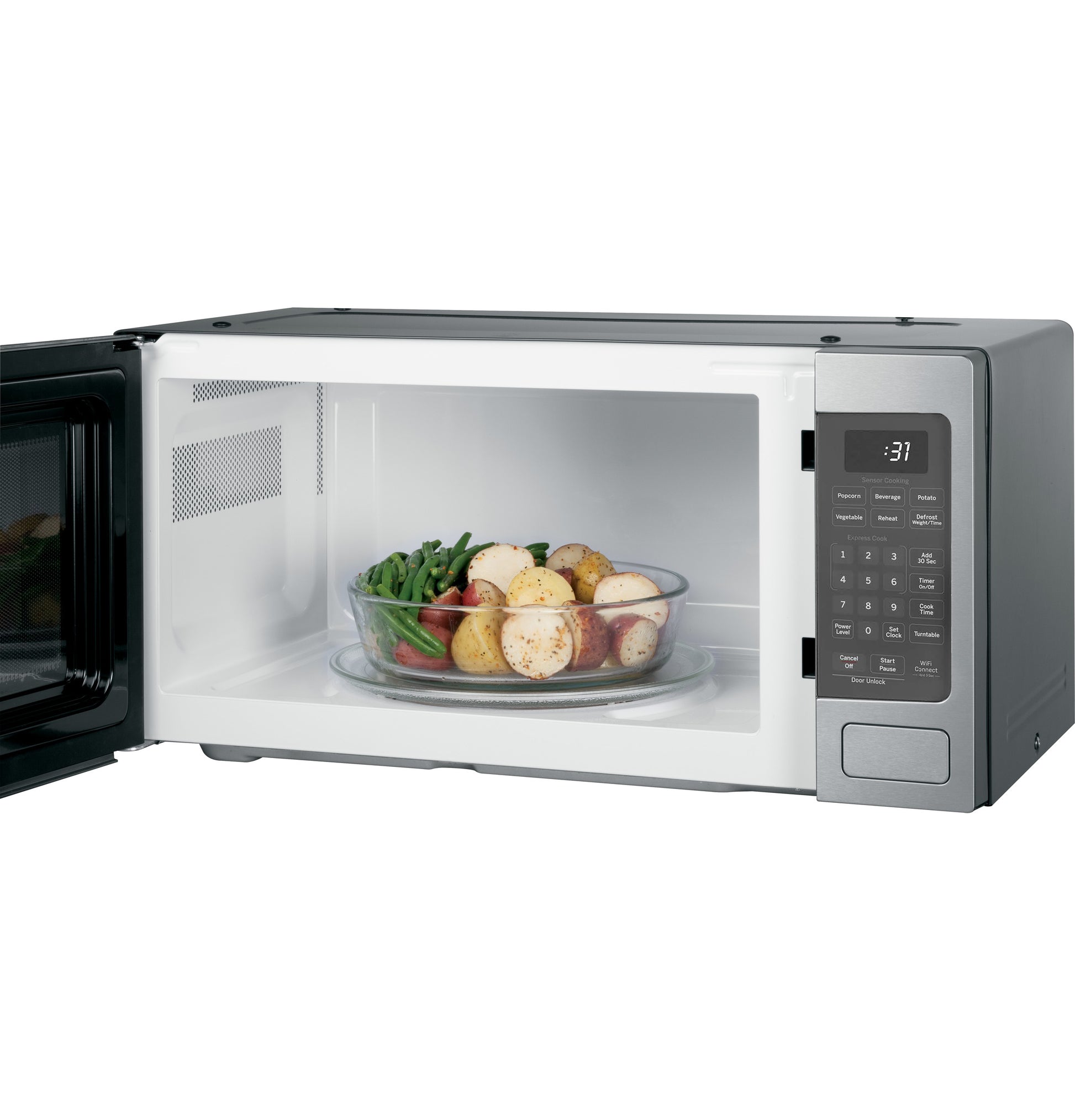 Countertop microwave oven with digital display and control panel, open door showing vegetables and potatoes inside from appliances collection