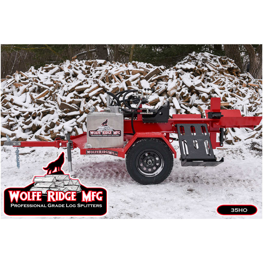 Red Wolfe Ridge 28 Ton commercial log splitter with hydraulic controls on snowy ground near large stacked firewood pile