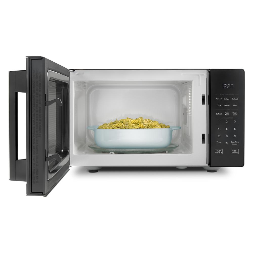 Black countertop microwave with open door, digital touch controls, white LED display, and food inside from Appliances collection