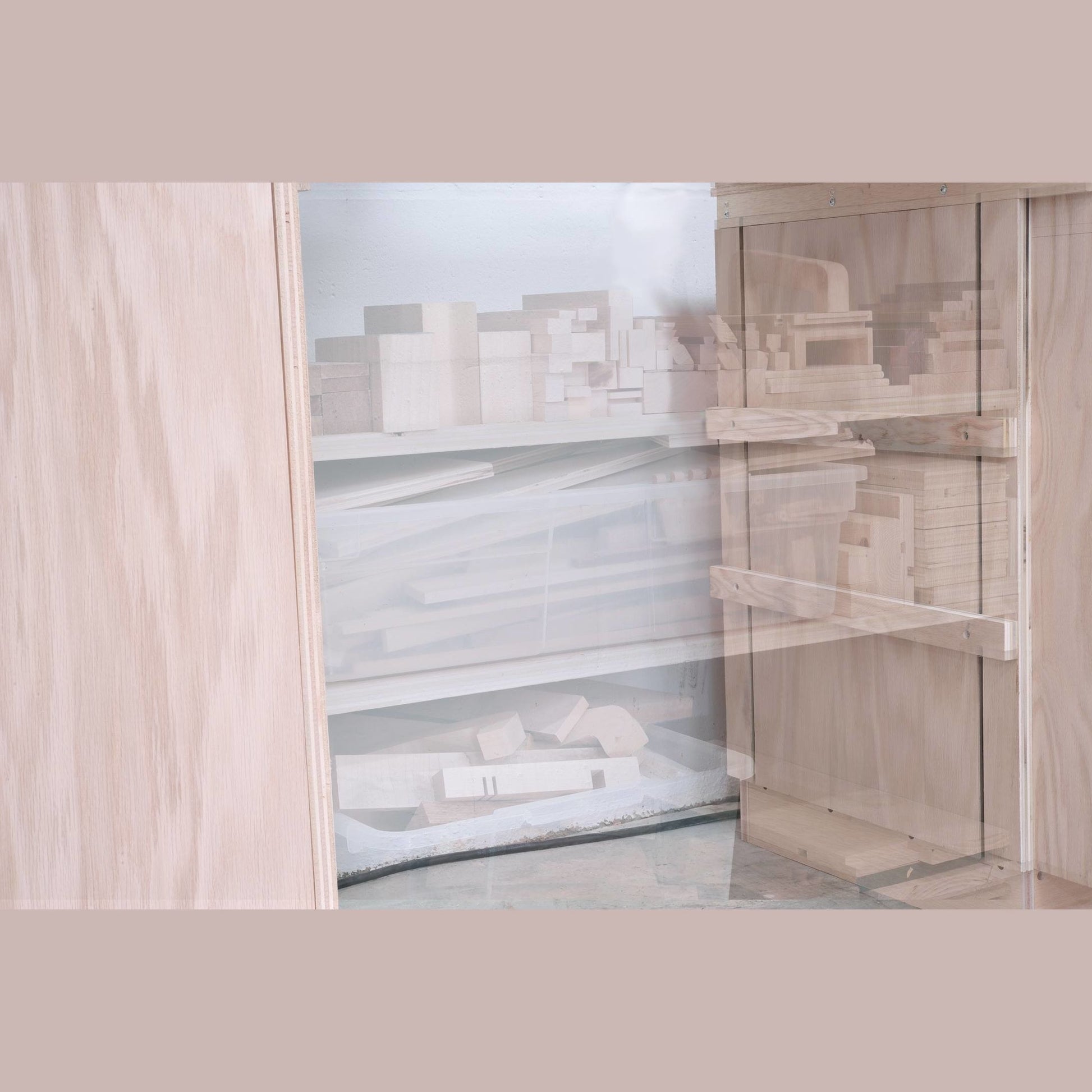Light wood cabinet interior showing organized shelves with various woodworking blocks and tools inside