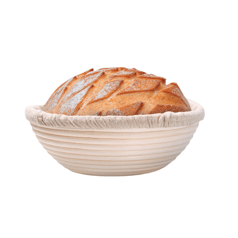 Round natural fiber bread proofing basket with linen liner holding artisan bread in kitchenware and home baking collection
