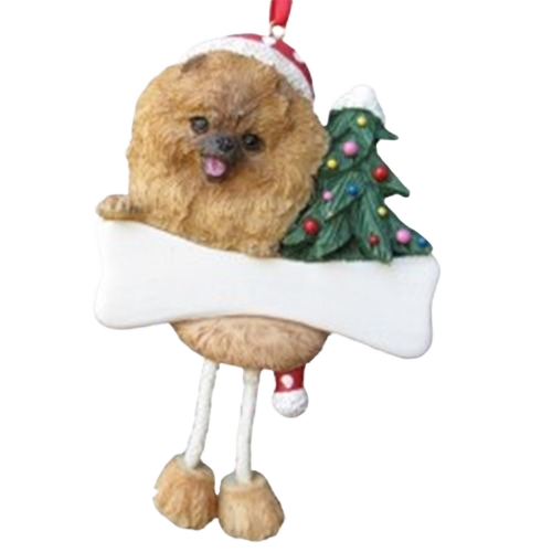 Playful Pomeranian ornament with dangling legs holding a blank bone and Christmas tree for holiday decoration collections under $50