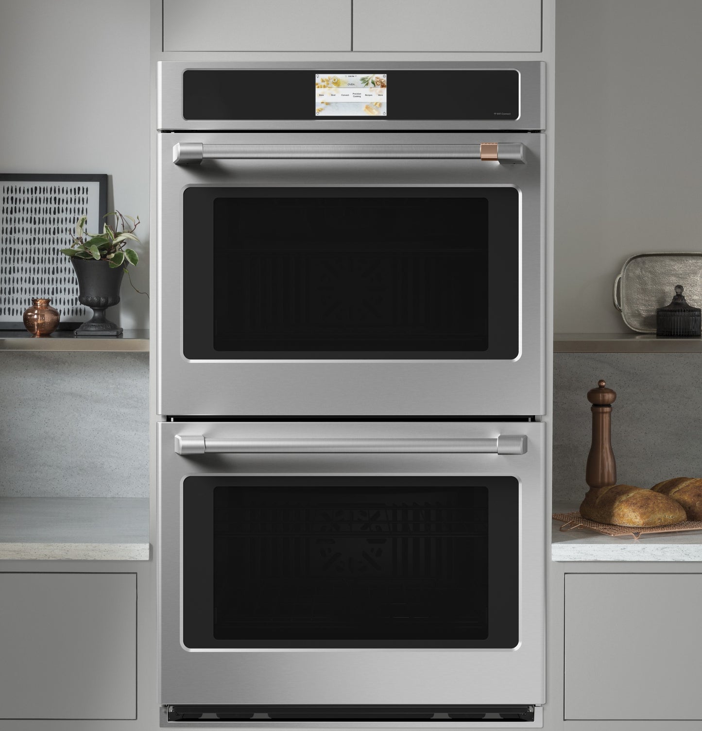Stainless steel smart double wall oven with touchscreen control, built into modern kitchen cabinetry from Appliances collection