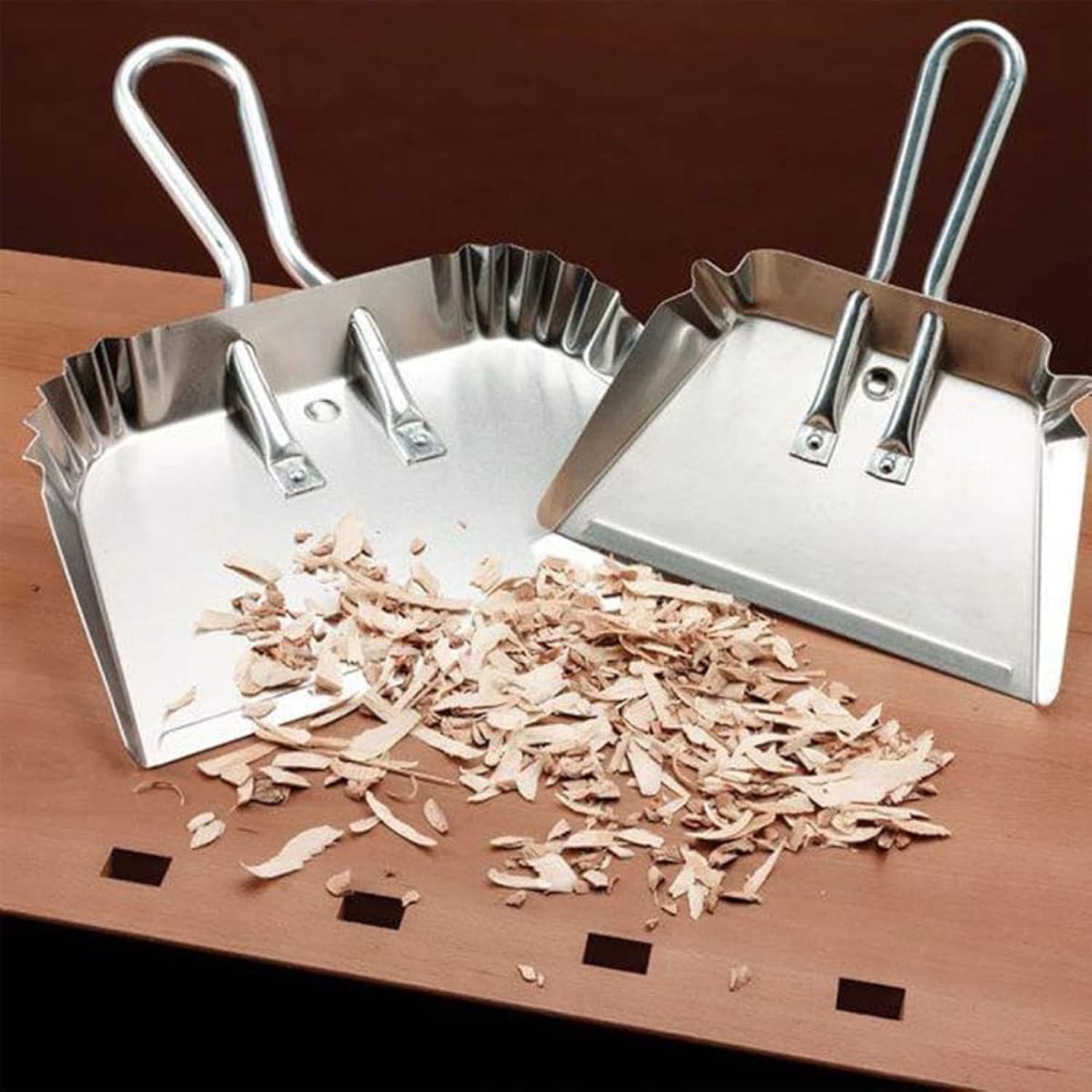 Two metal dust pans with raised edges for collecting wood shavings in woodworking and home improvement tasks