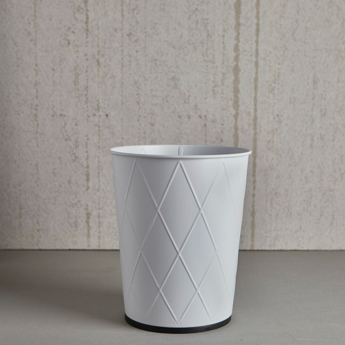 White waste basket with subtle harlequin pattern and black base for bathroom and home organization under $50