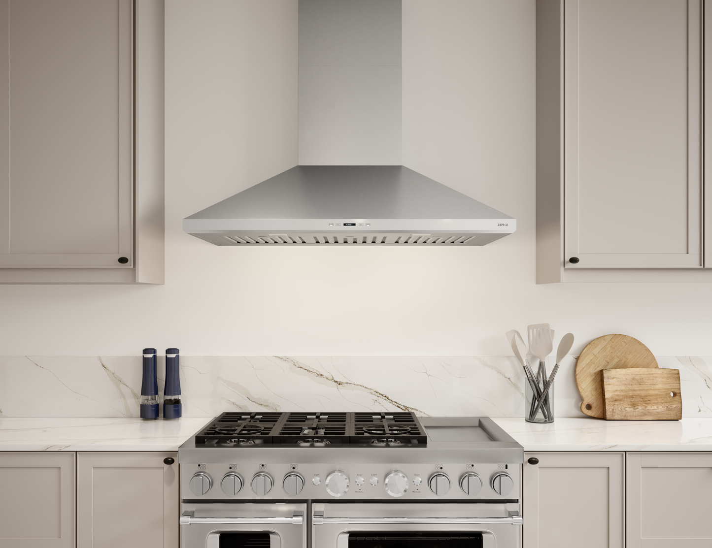 Stainless steel wall-mounted range hood with LED lighting over gas stove in kitchen and appliances collection