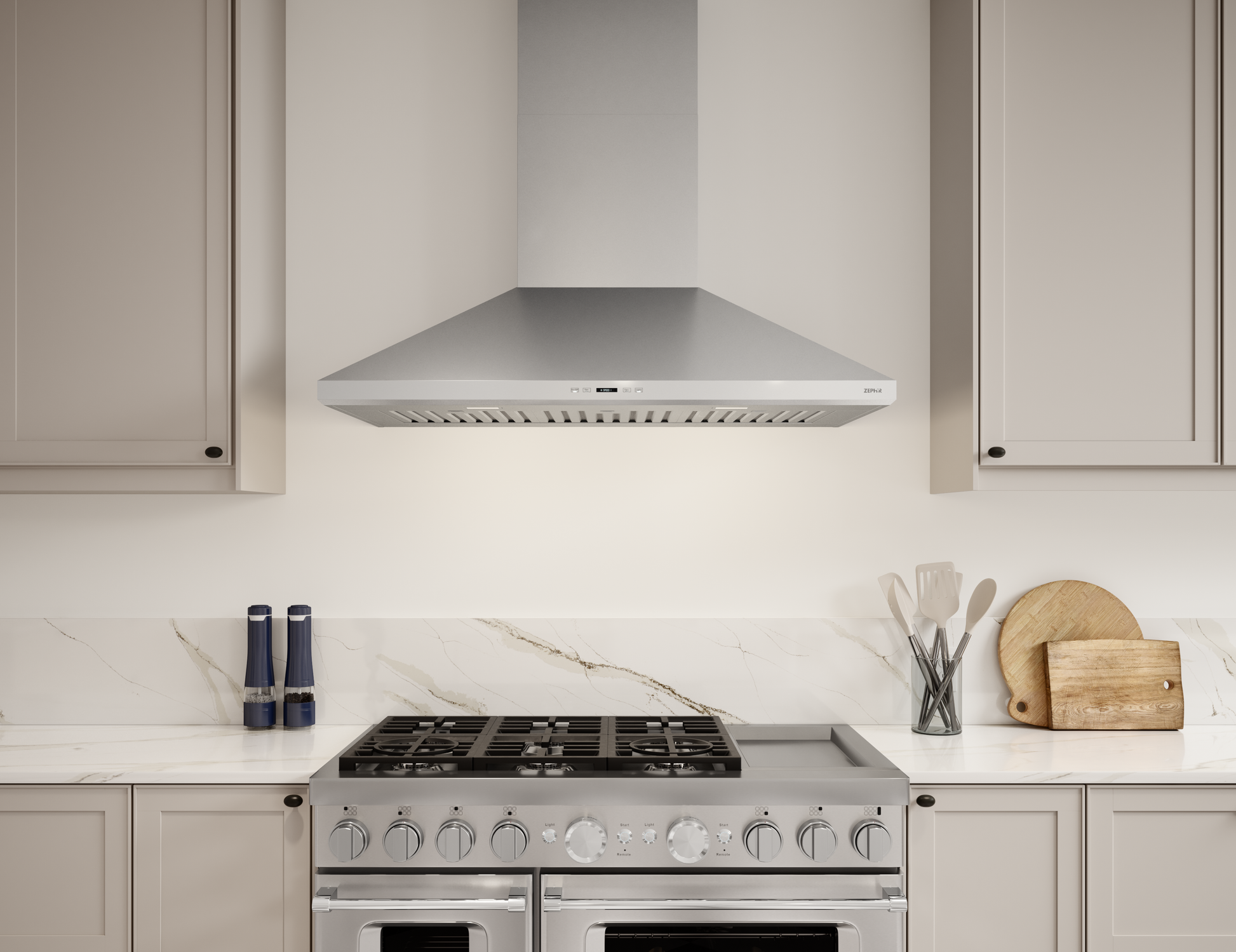 Stainless steel wall-mounted range hood with LED lighting over gas stove in kitchen and appliances collection
