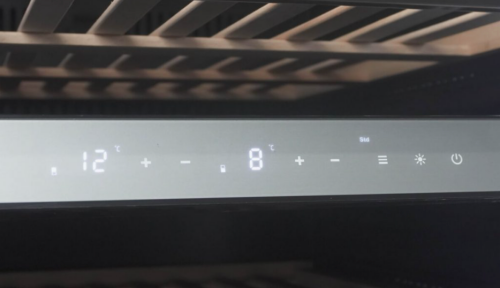 Digital control panel displaying temperature settings and functions on a black wine cooler in Appliances collection