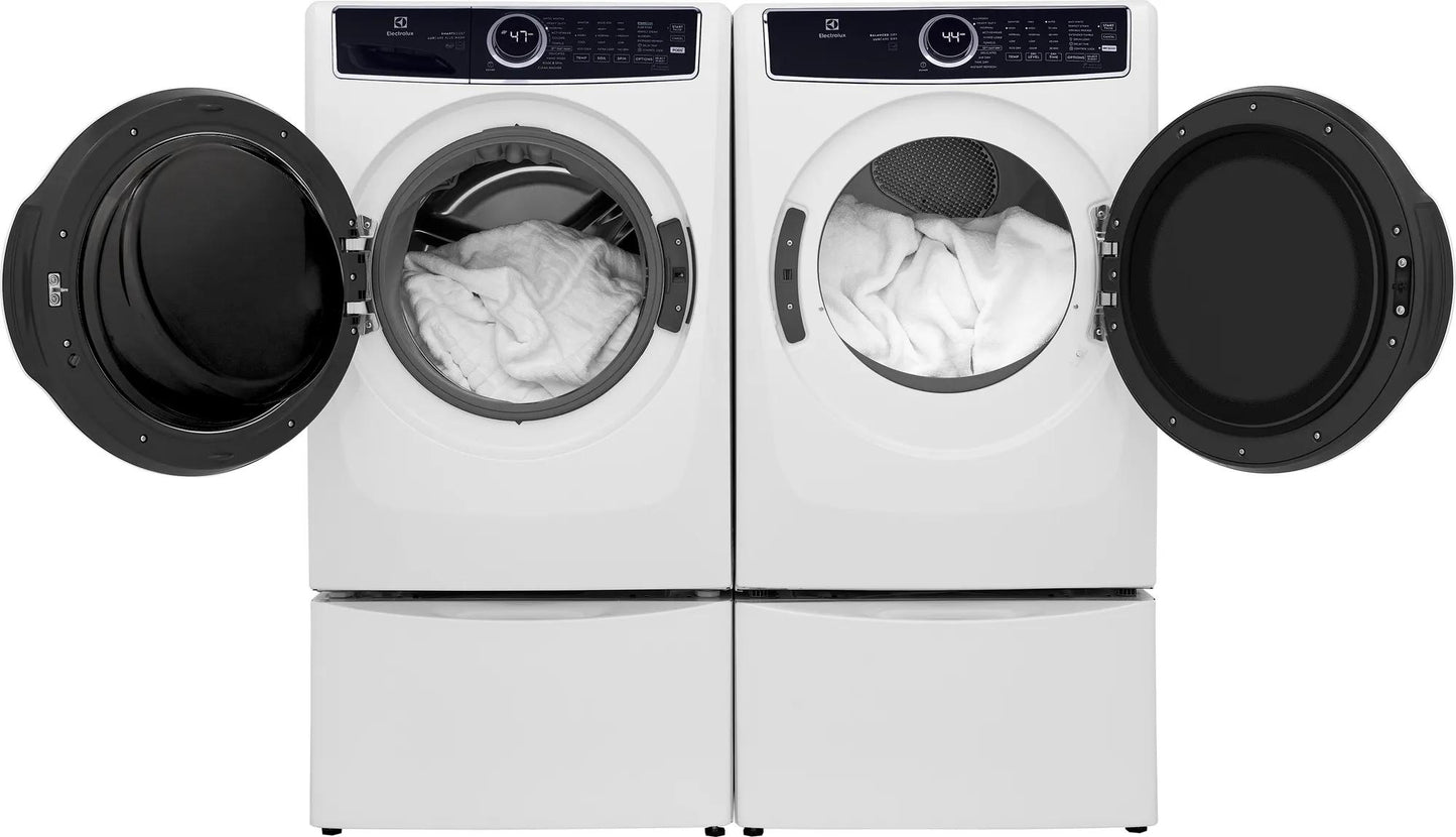 White front load washer and dryer pair with open doors showing white towels in modern appliances collection