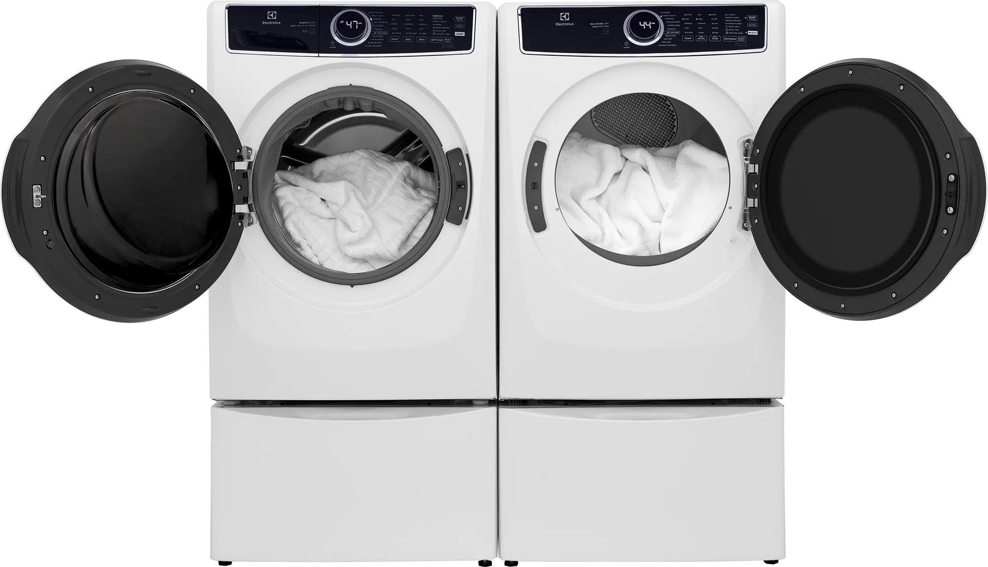 White front load washer and dryer pair with open doors showing white towels in modern appliances collection