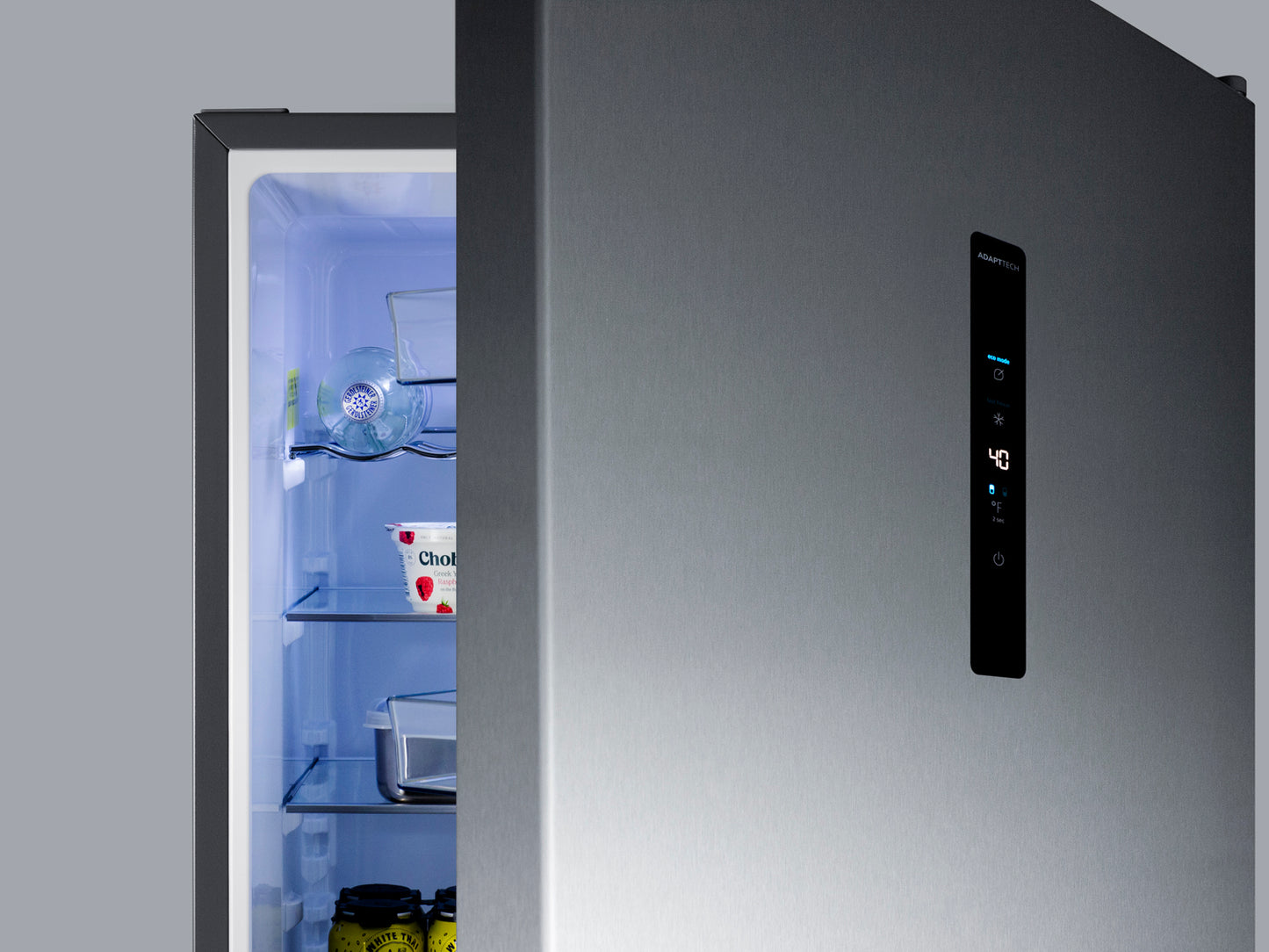 Stainless steel 24-inch bottom freezer refrigerator with icemaker and digital display in modern kitchen appliance setting