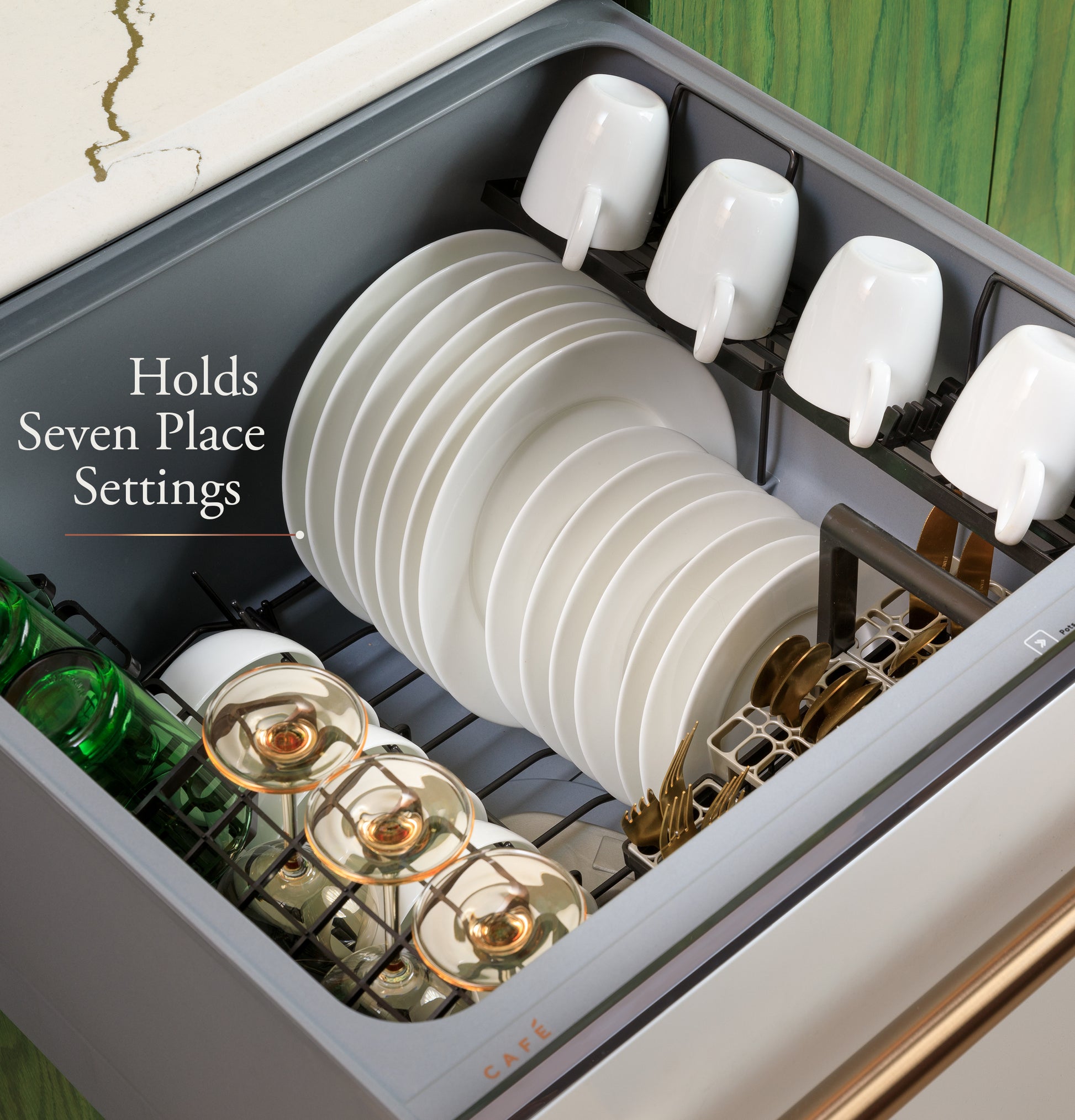 Open smart dishwasher drawer loaded with white plates, mugs, and glasses in modern kitchen setting