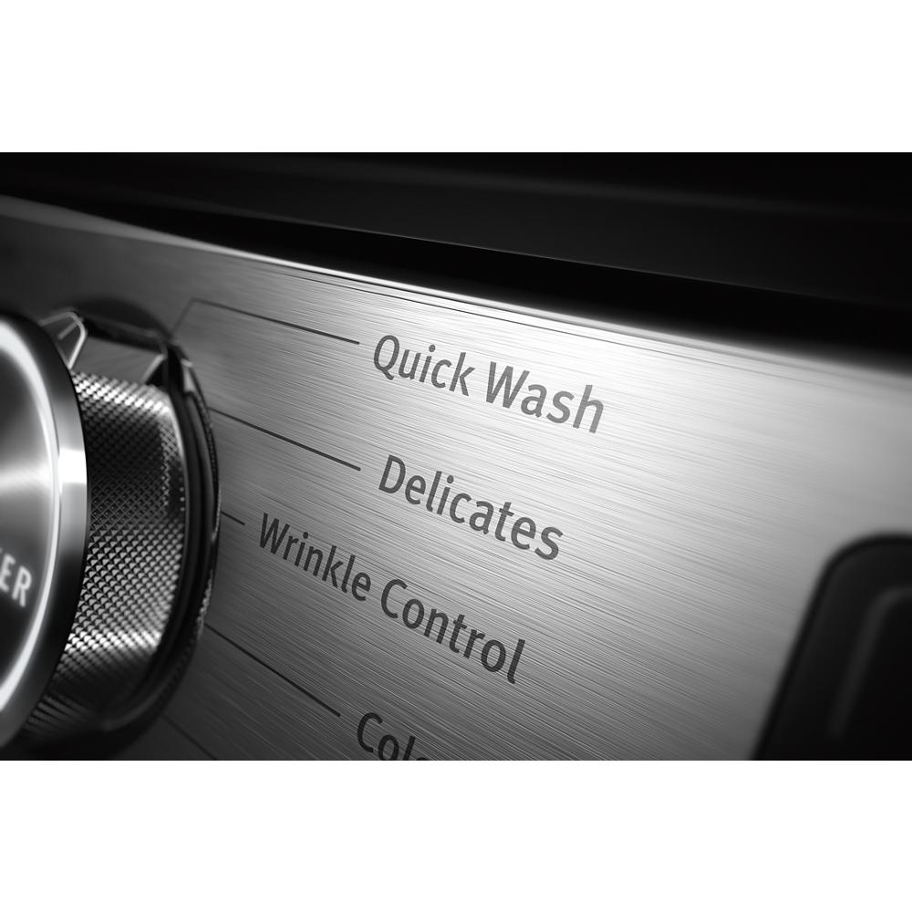 Close-up of stainless steel control panel showing Quick Wash, Delicates, and Wrinkle Control settings on front load washer