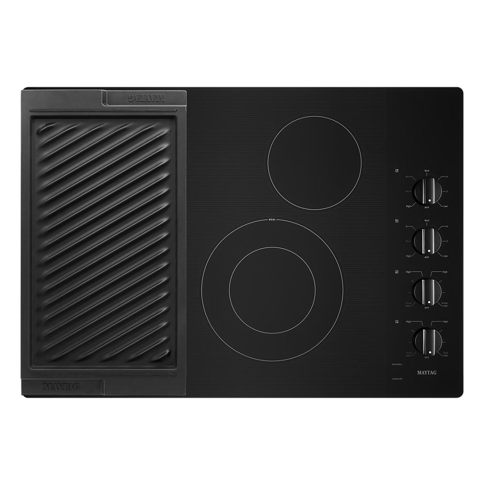 Black electric cooktop featuring dual heating elements, reversible grill and griddle, with four rotary control knobs from cooktops collection