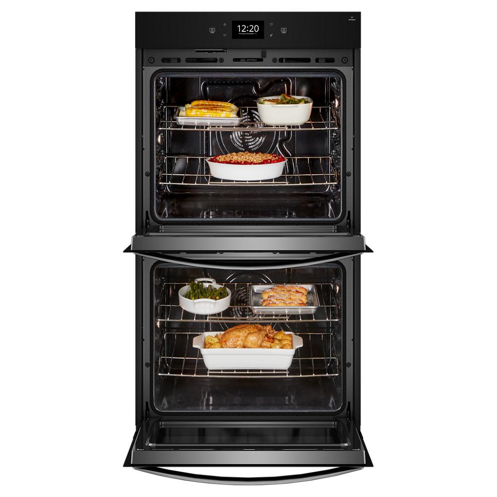 Black double wall oven with open doors cooking multiple dishes inside in kitchen appliances collection