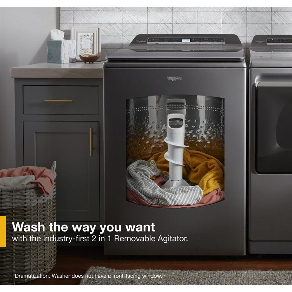 Dark gray top load washer with 2 in 1 removable agitator shown with laundry inside drum in modern laundry room environment