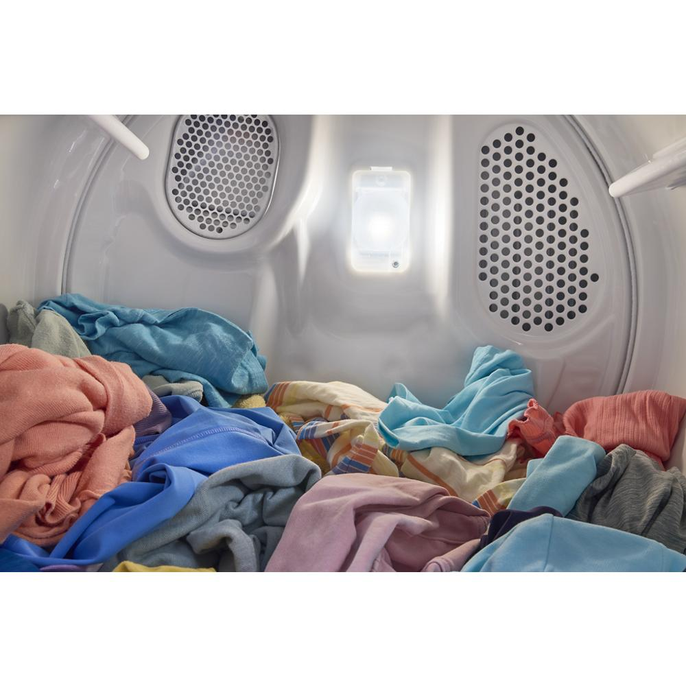 Interior view of a vented electric dryer drum filled with colorful clothes from washers and dryers appliances collection