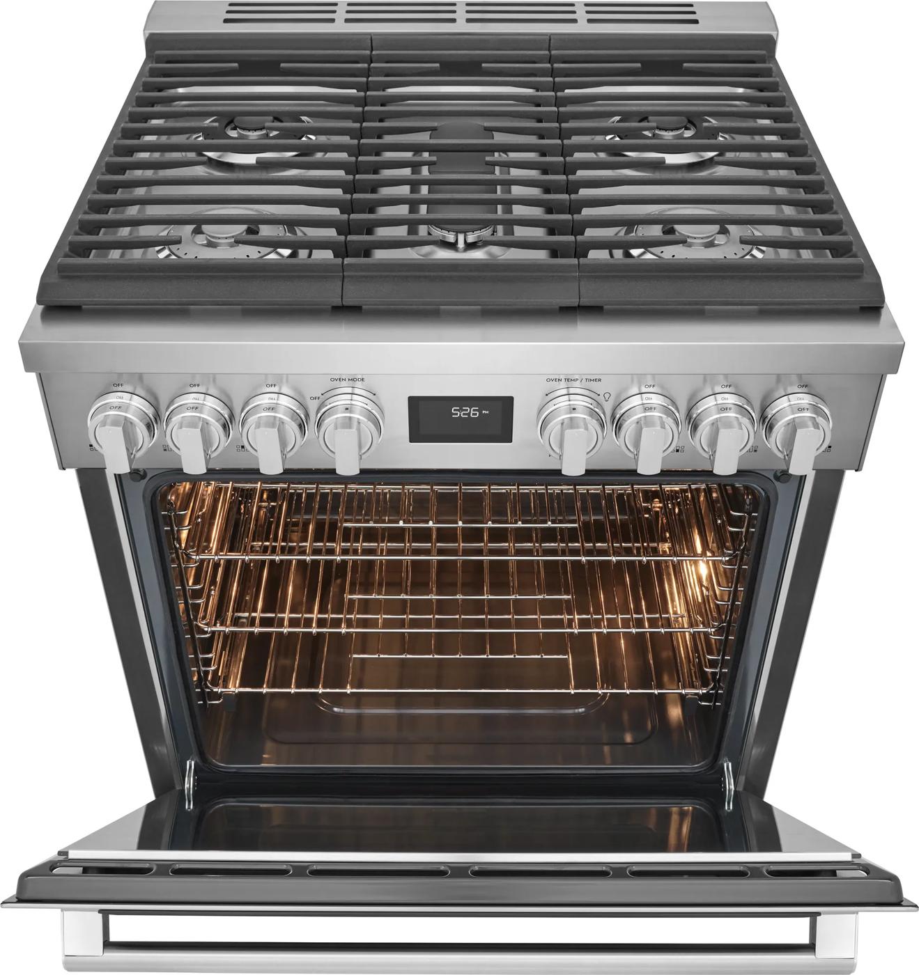 Open stainless steel dual-fuel range with six gas burners and illuminated electric oven in kitchen appliance collection