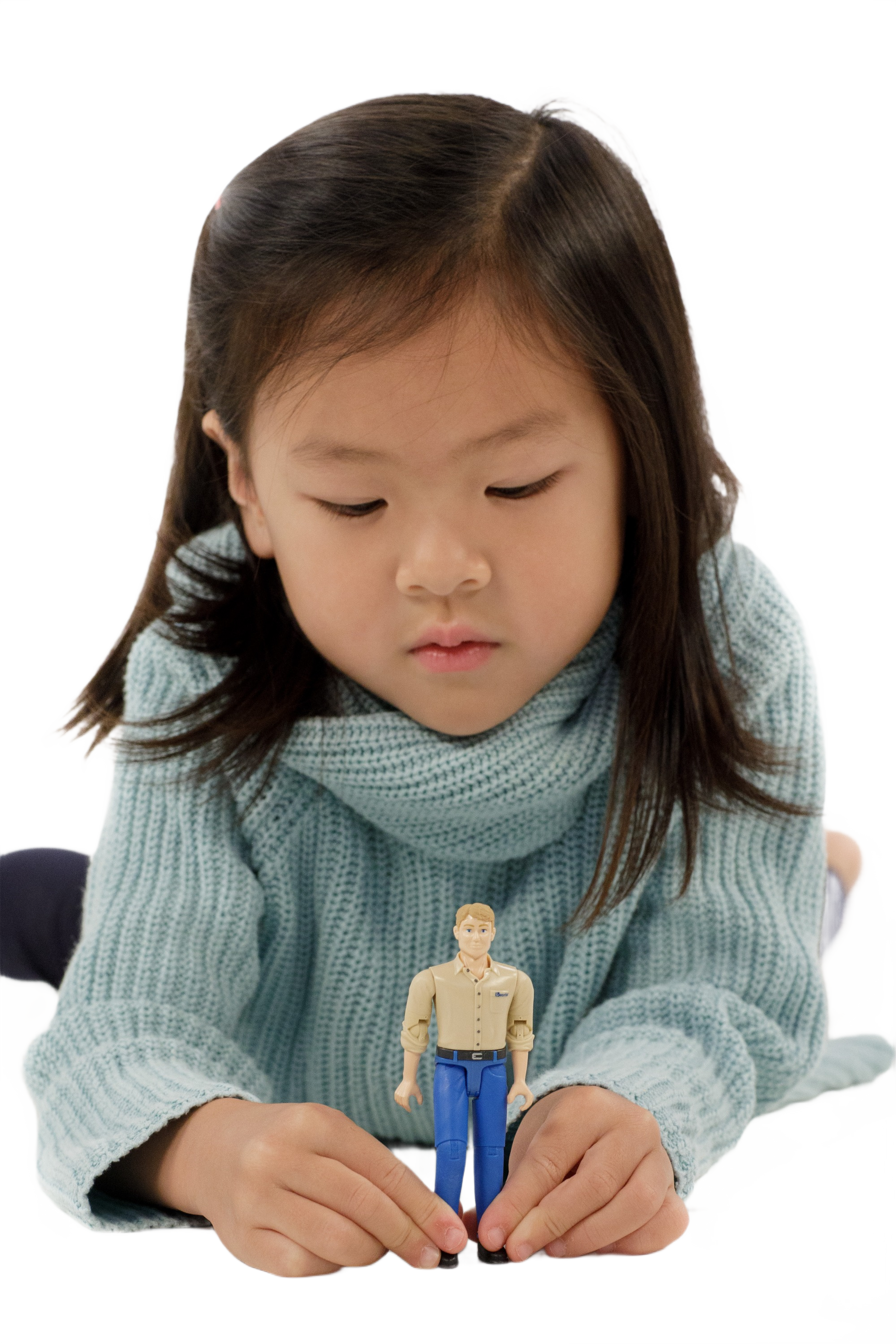 Young child in blue sweater playing with a light skin man action figure wearing blue jeans and tan shirt