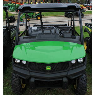 Green full-size crossover utility vehicle with cab roof and rugged tires designed for outdoor work and home improvement tasks