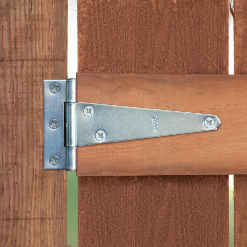 Pair of zinc plated 5-inch light duty T-hinges installed on wooden gate for home improvement hardware projects under $50