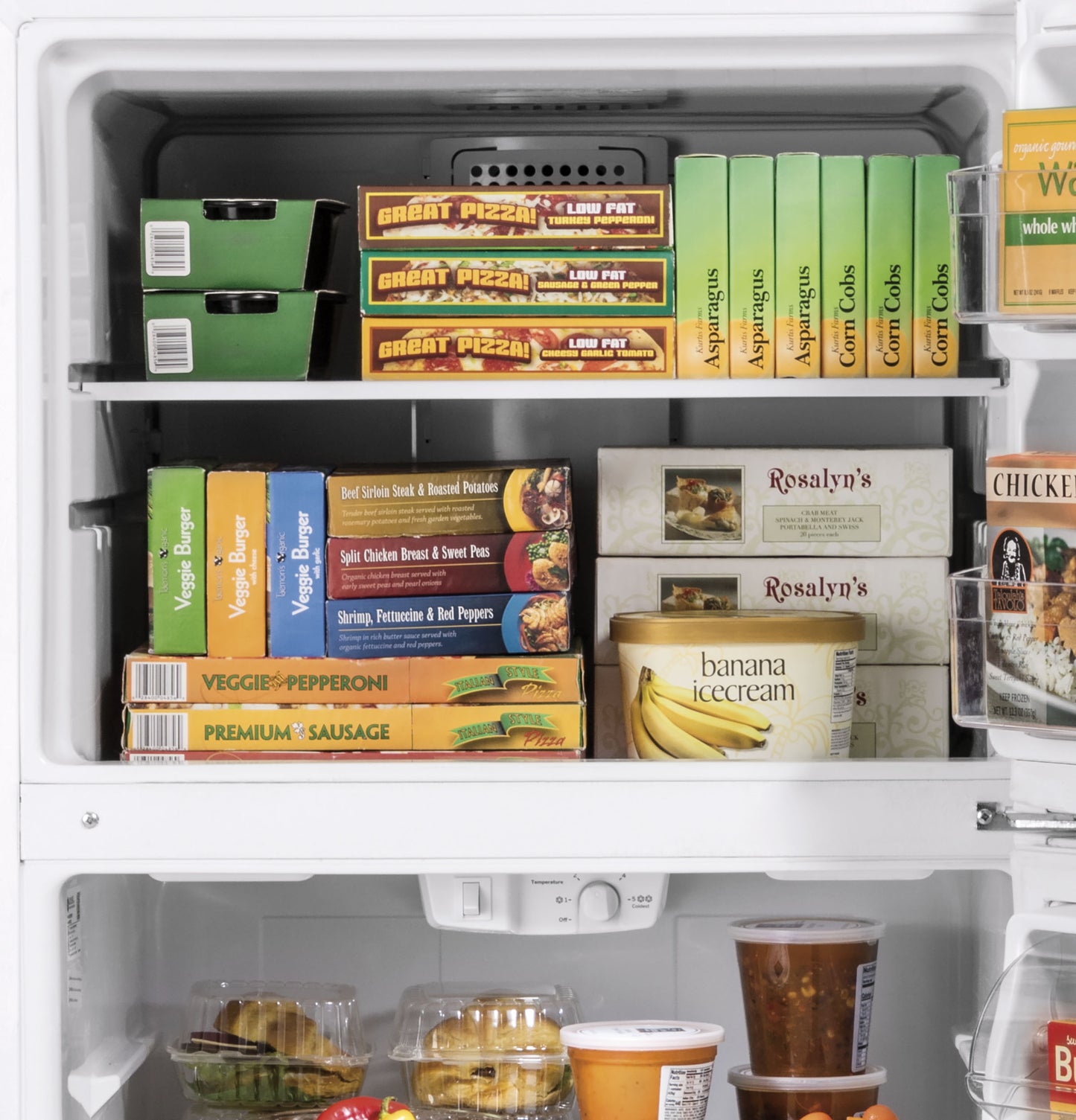 Open freezer compartment with organized frozen pizzas, vegetable burgers, ice cream, and frozen desserts inside a white refrigerator
