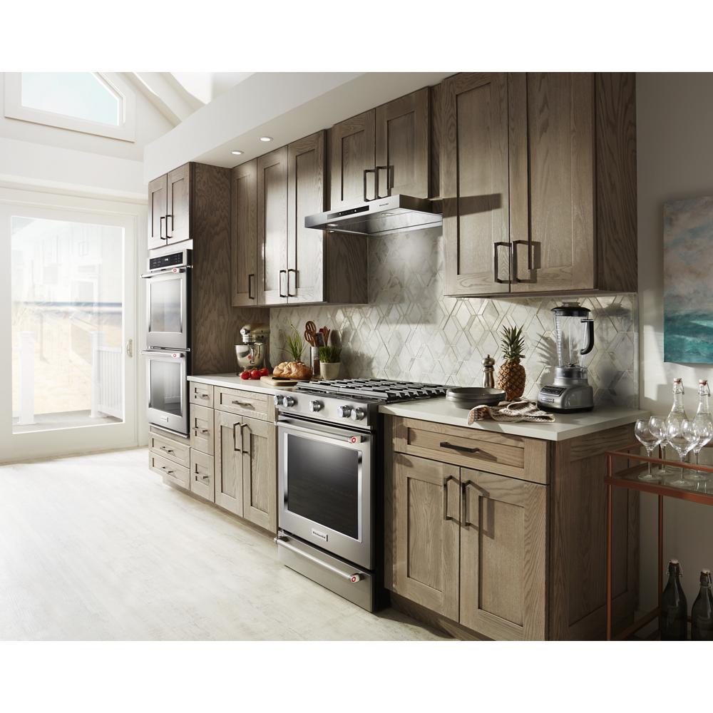 Modern kitchen with stainless steel 36" low-profile under-cabinet ventilation hood and wood cabinetry from KitchenAid collection