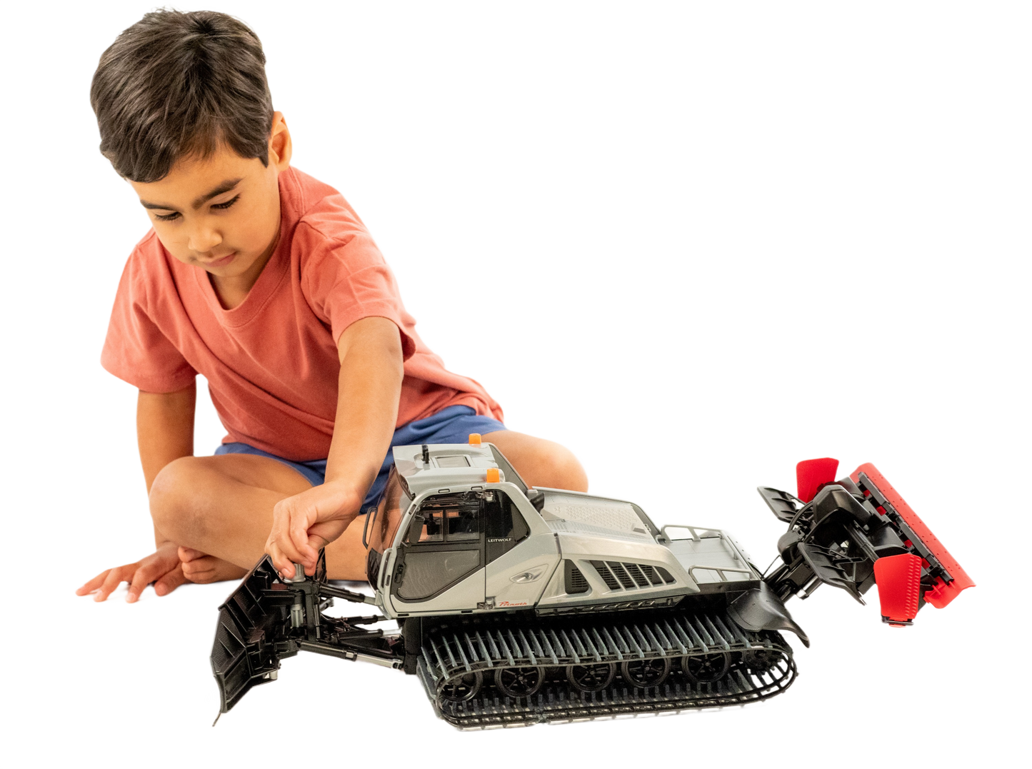 Child playing with detailed Bruder Prinoth Leitwolf snow groomer toy featuring tracked wheels and adjustable front blade