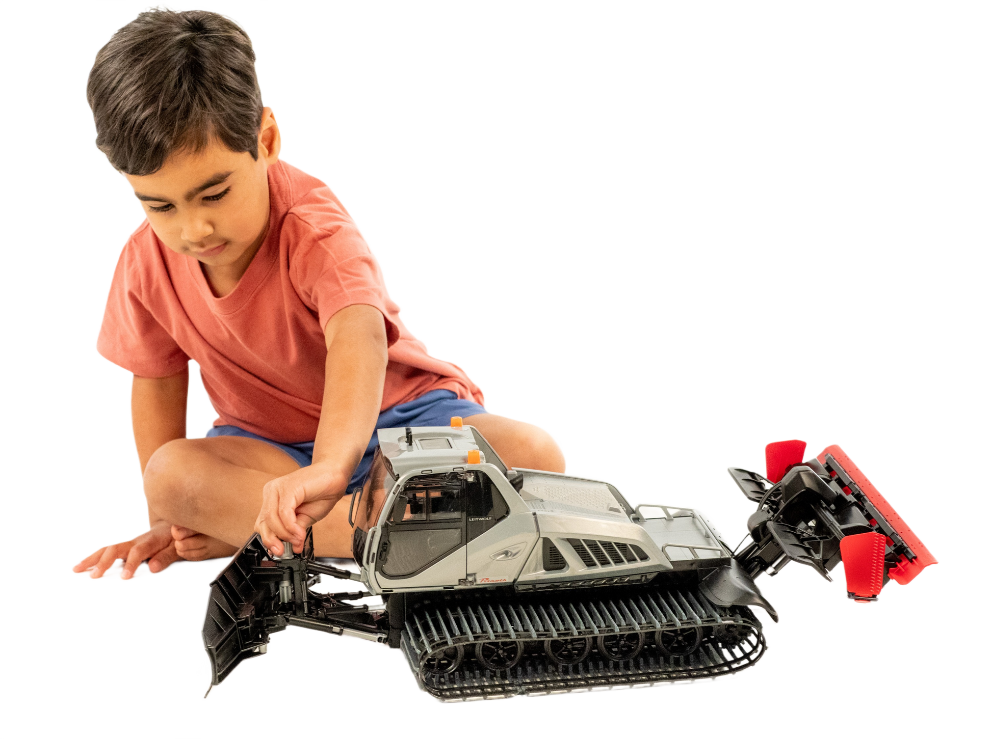 Child playing with detailed Bruder Prinoth Leitwolf snow groomer toy featuring tracked wheels and adjustable front blade