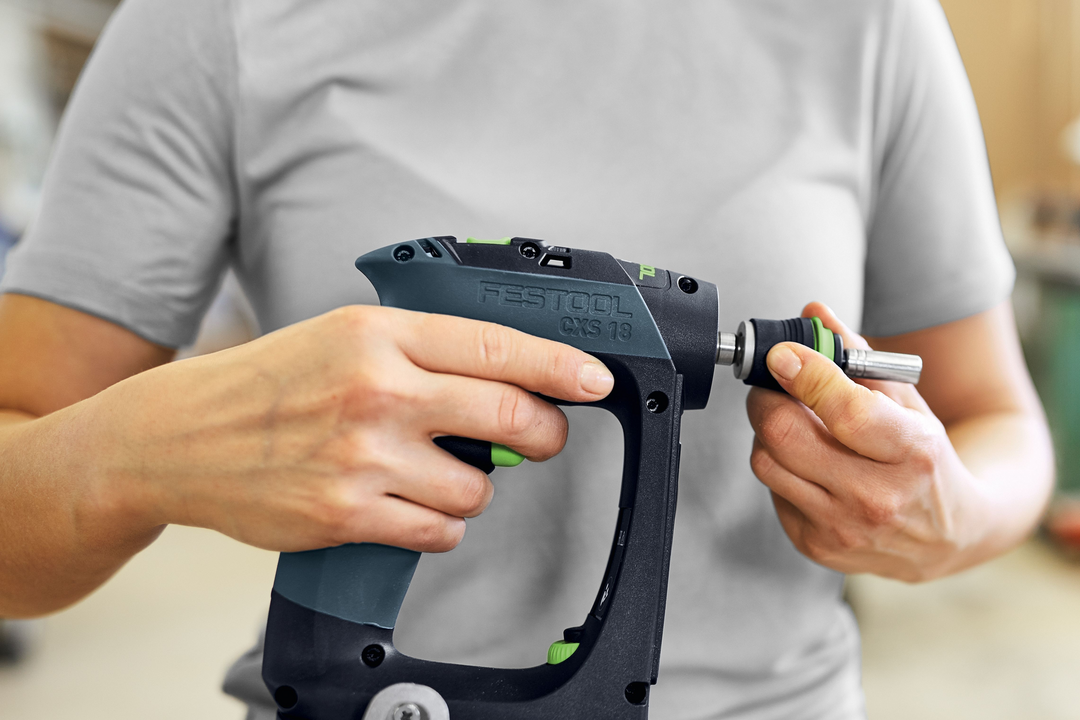 Person attaching screwdriver bit to Festool cordless drill for tools and home improvement tasks