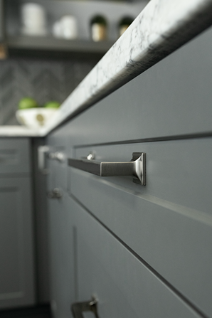 Satin nickel cabinet pull with modern square bases on gray kitchen drawers for home improvement projects