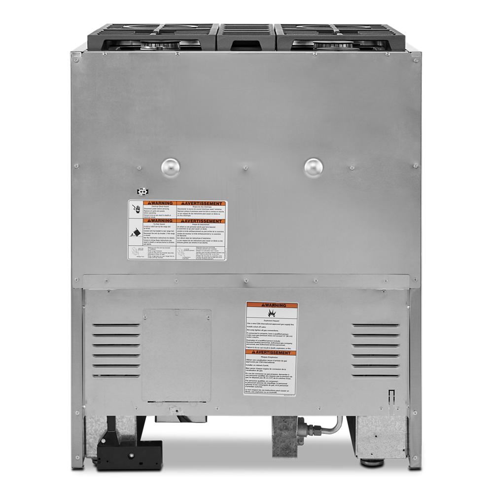Rear view of commercial-style dual fuel range showing vent panels, gas connection, and safety labels