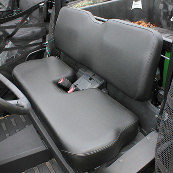 Black bench seat with seat belts in mid-size utility vehicle interior for outdoor and home improvement use